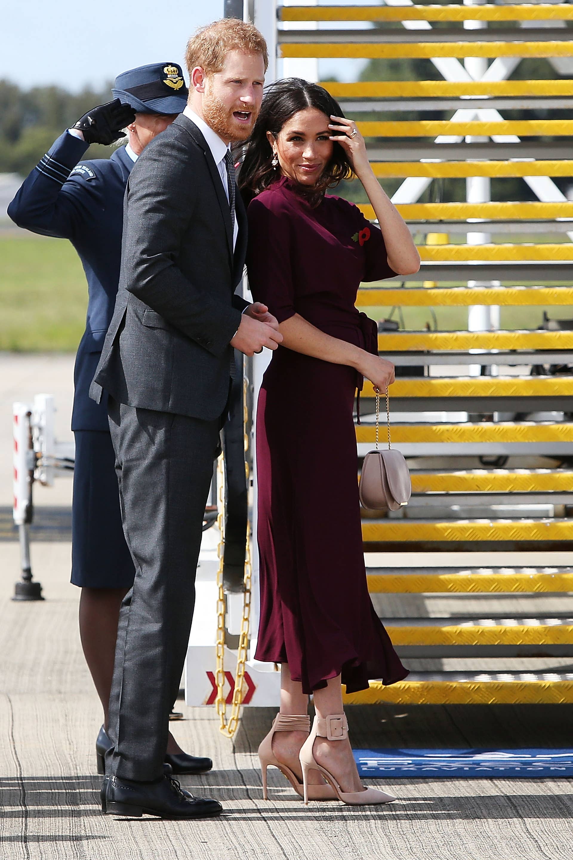 Meghan Markle Wore a Thing: Burgundy Hugo Boss Dress En Route to New Zealand Edition