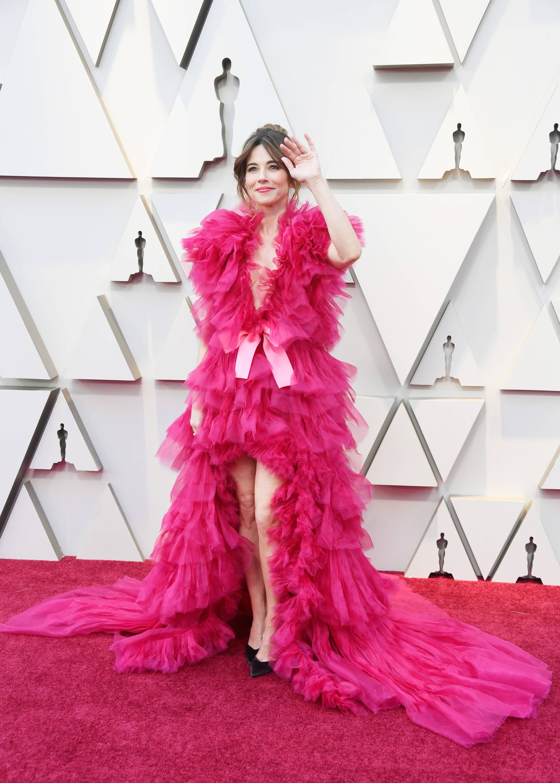 pink dress at the oscars Ariana Grande's Oscars Dress Pops With Pink Drama on the Red Carpet