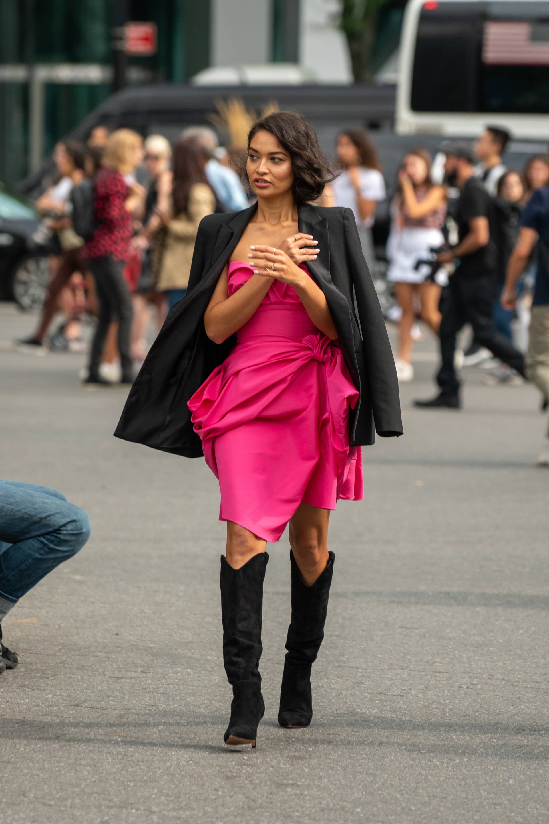pink dress black boots Showgoer wears hot pink mini dress with puff sleeves and pairs with chunky black biker boots