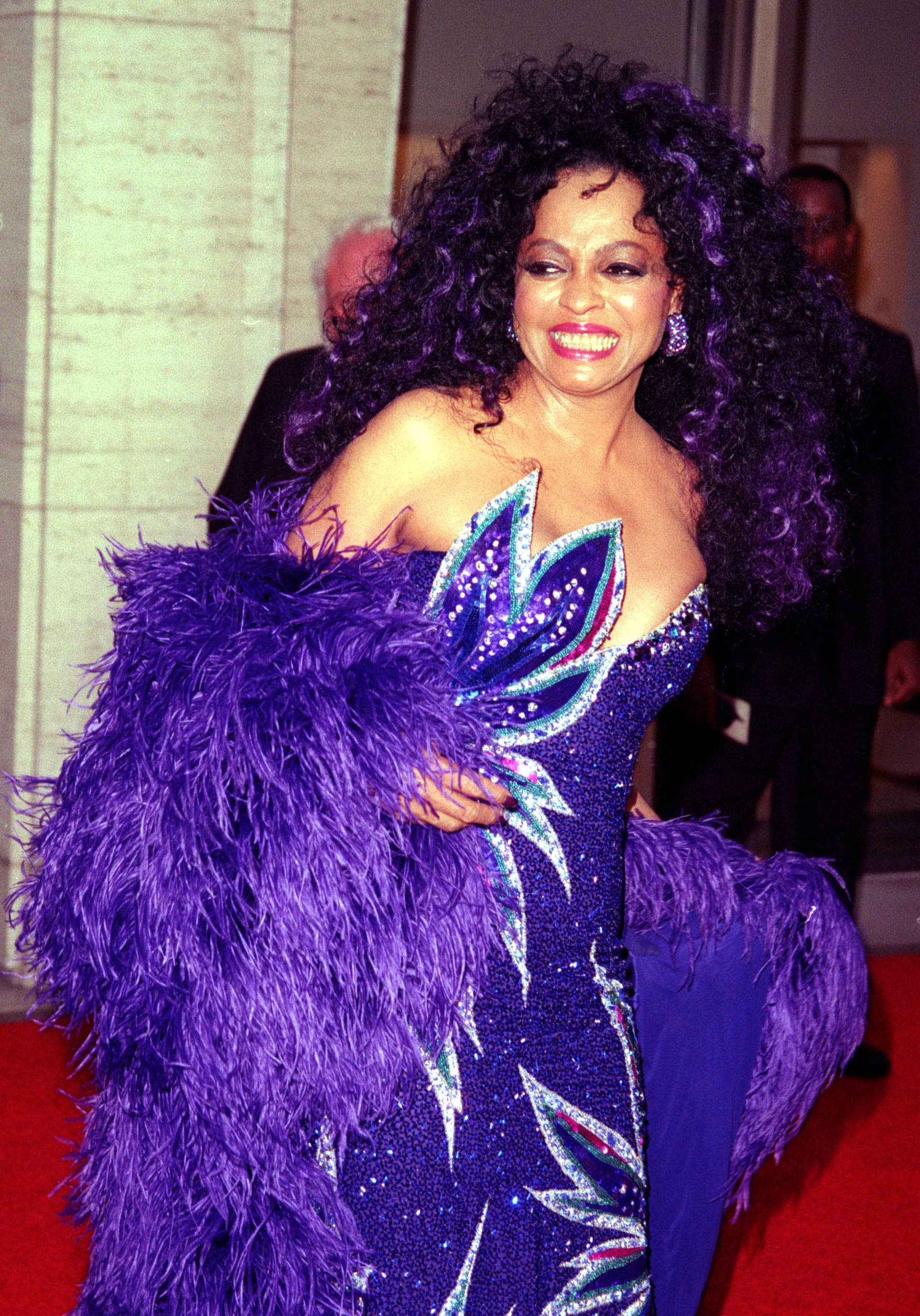 diana ross purple dress Diana Ross is a vision in a purple Bob Mackie dress. 1975. One of the  scenes in the movie Mahogany when she's being photographed by Tony  Perkins for a Revlon campaign. Her