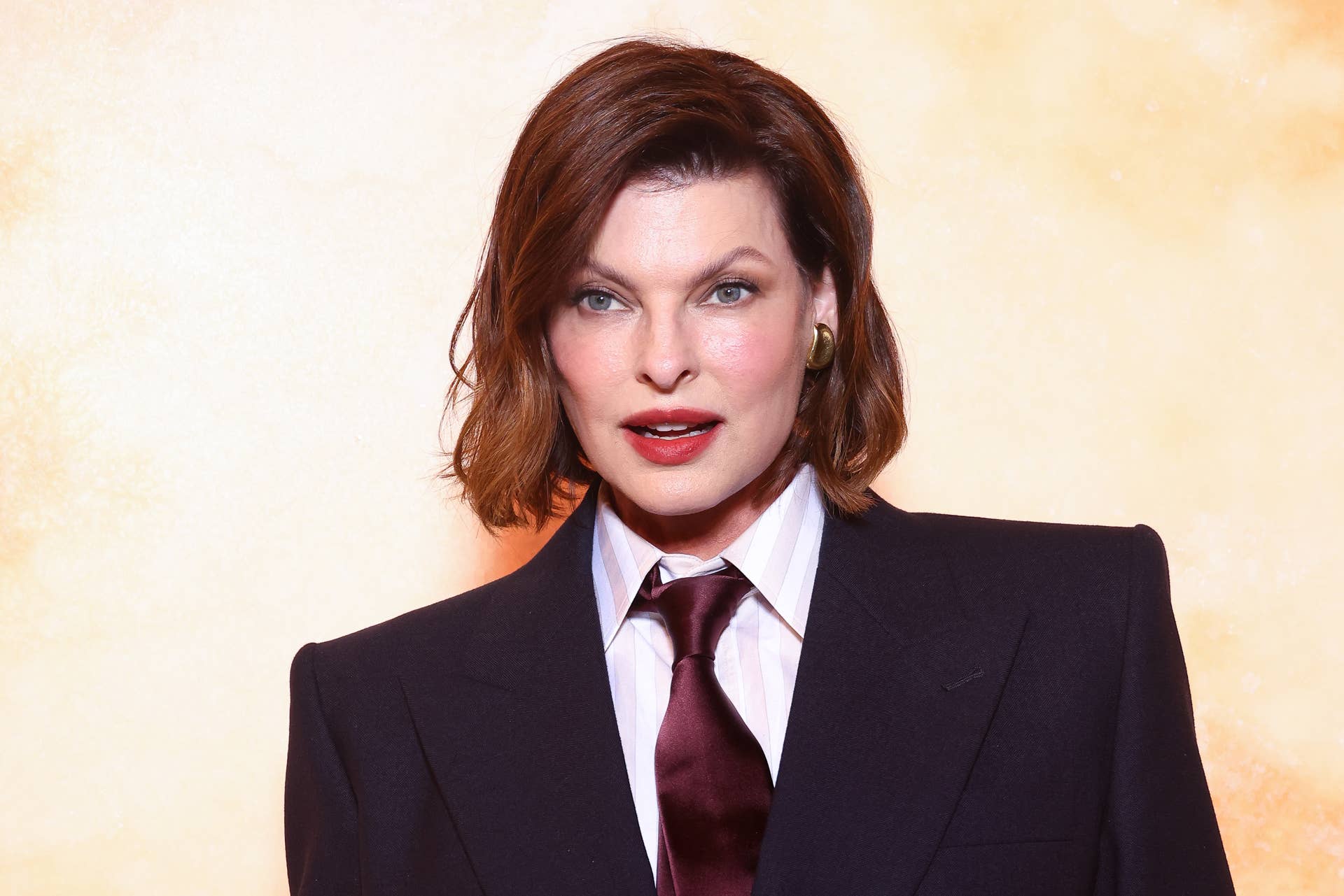 linda evangelista red dress Linda Evangelista presenting a red John Galliano dress in the colors... News Photo