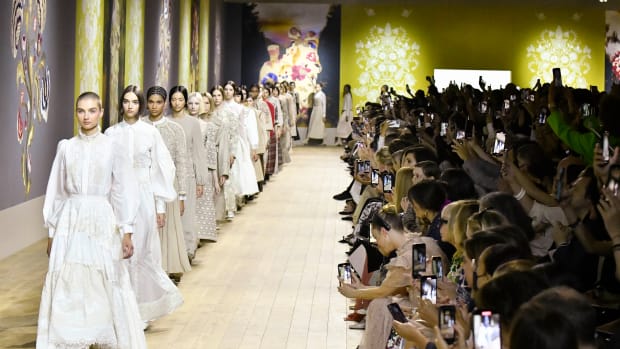 Models walk down the Dior Paris Haute Couture Runway.