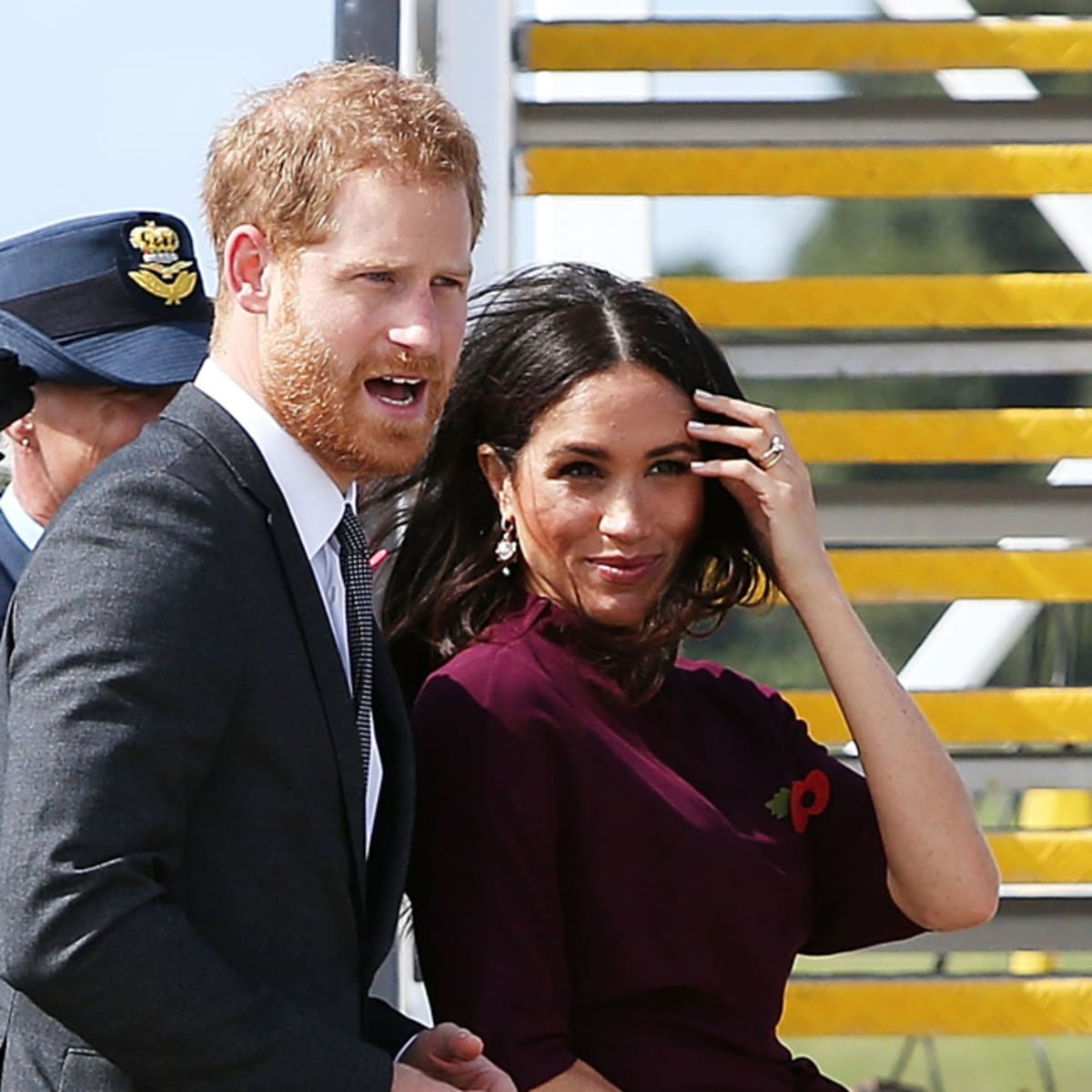 Meghan Markle Wore a Thing Burgundy Hugo Boss Dress En Route to