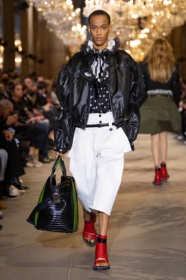 Protestor on Louis Vuitton SS22 Runway Show