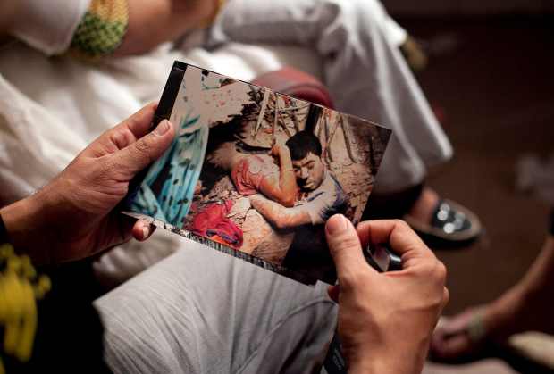 A Bangladeshi man holds a photo from the Rana Plaza disaster. Photo: Getty Images