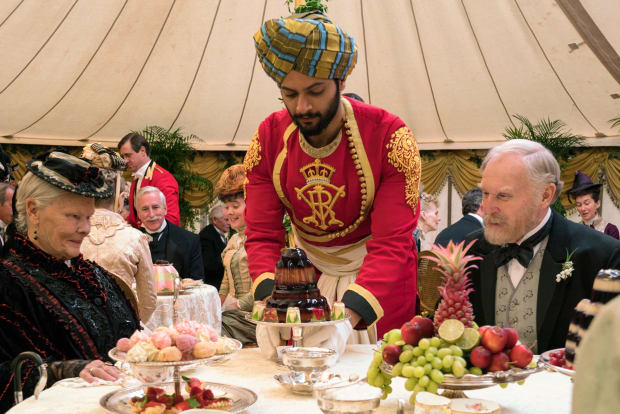 Queen Victoria (Judi Dench), Abdul Karim (Ali Fazal), a jello mold and Sir Henry Ponsonby (Tim Pigott-Smith) Photo: Peter Mountain / Focus Features