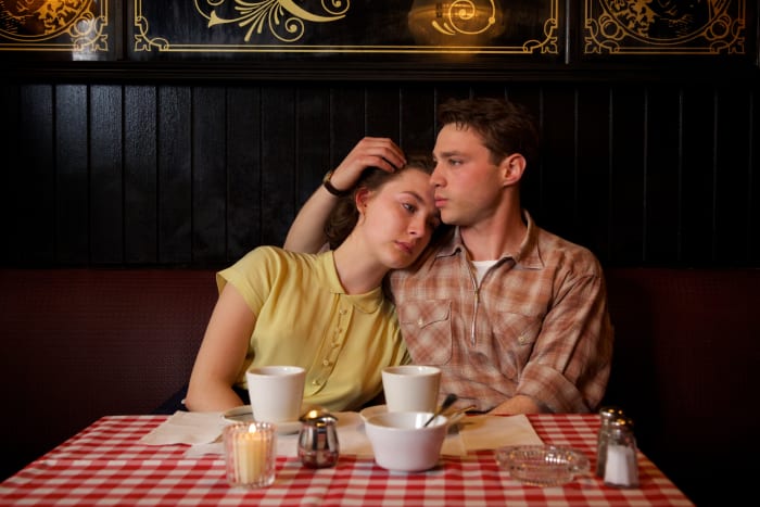 Eilis (Saoirse Ronan) in the yellow dress inspired by Dicks-Mireaux's mother and a plaid-sporting Tony (Emory Cohen). Photo: Kerry Brown/Twentieth Century Fox Film Corporation