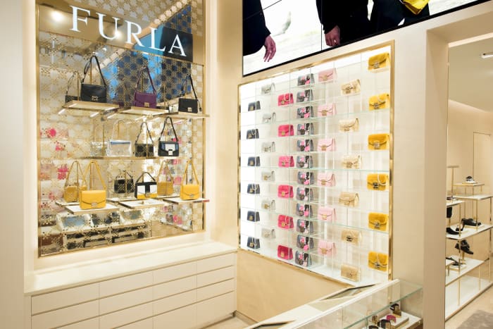 Inside Furla's new Fifth Avenue flagship, where the company's best-selling Metropolis bag is on display (right). Photo: Furla