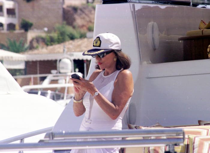 Actress Joan Collins aboard Valentino's yacht in Mallorca in the summer of 2001. Photo: Roberto Fernandez/Interactive Press/Getty Images