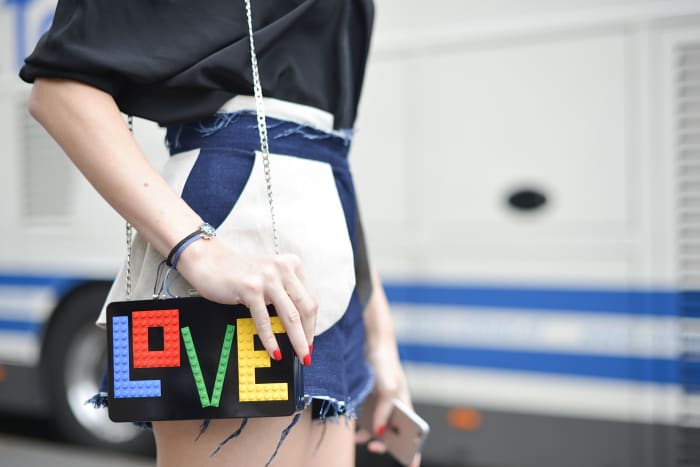 A guest poses with a Les Petits Joueurs bag before the Alexis Mabille presentation at the Opera Garnier on July 8, 2015 in Paris, France. (Photo by Vanni Bassetti/Getty Images)