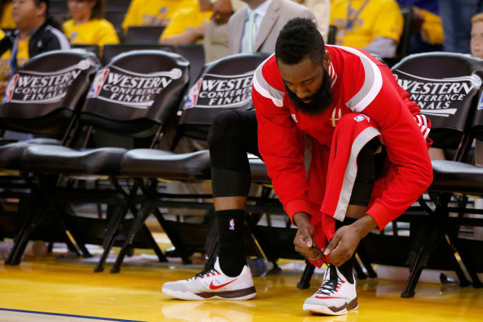 James Harden of the Houston Rockets ties the laces on his Nike shoes in May. Photo: Ezra Shaw/Getty Images
