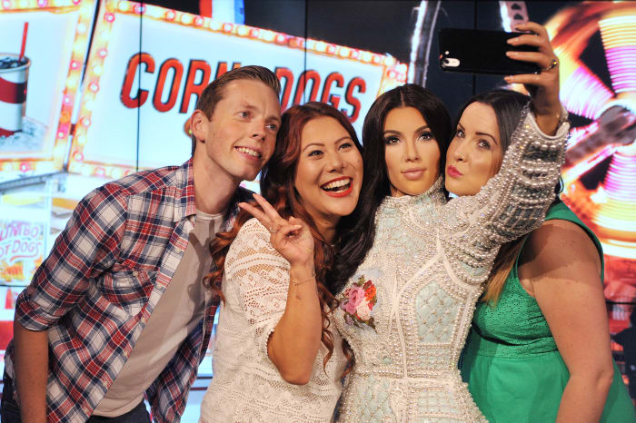 Fans posing with Kim Kardashian's Madame Tussauds wax figure in London. Photo: Tabatha Fireman/Getty Images