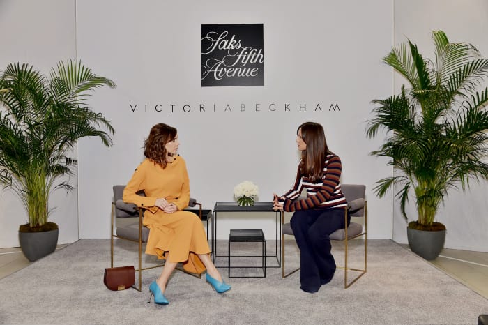Victoria Beckham chats with Saks Fifth Avenue Fashion Director Roopal Patel at the Saks flagship location. Photo: Mike Coppola/Getty Images