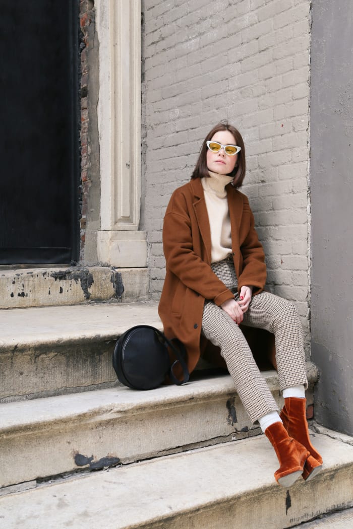 Reese Blutstein wearing The Arrivals coat, The Frankie Shop sweater, Nanushka pants, Reike Nen boots, Gucci glasses and a Sonya Lee purse. Photo: Whitney Bauck/Fashionista