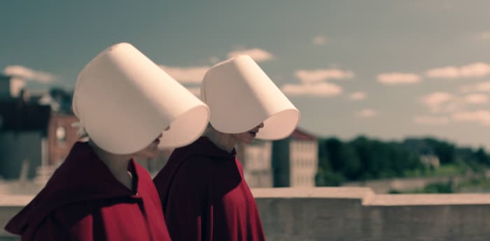 Offred (left) and Offglen (Alexis Bledel, right) wear their capes differently. Photo: Take Five/Hulu