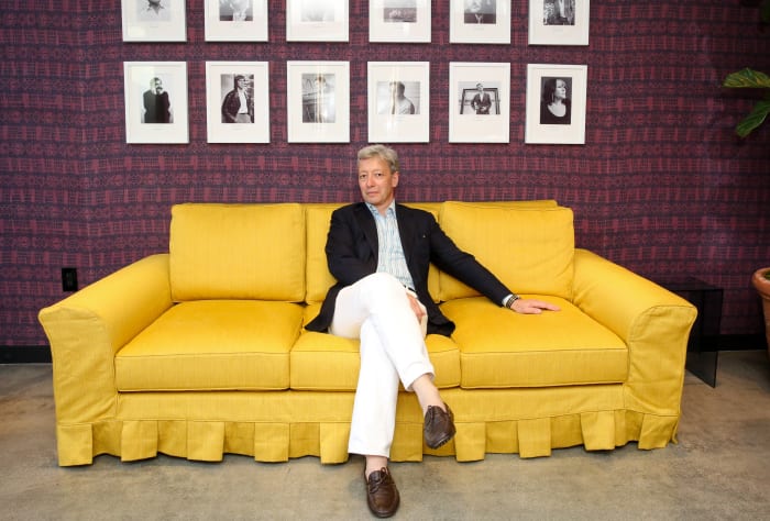Frederic Malle sits beneath portraits of his perfumers at his new Los Angeles store. Photo: Marc Patrick for BFA.com