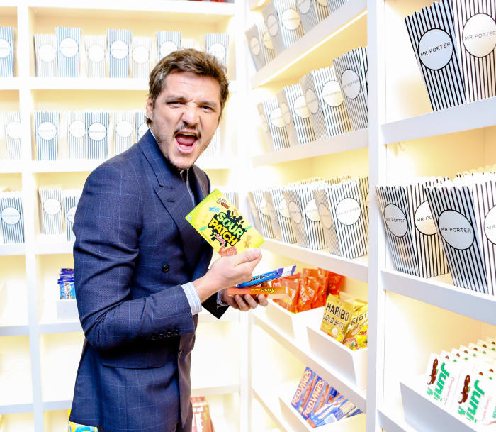 Pedro Pascal, in Kingsman x Mr. Porter, stocking up on snacks before the screening. Photo: courtesy Mr. Porter