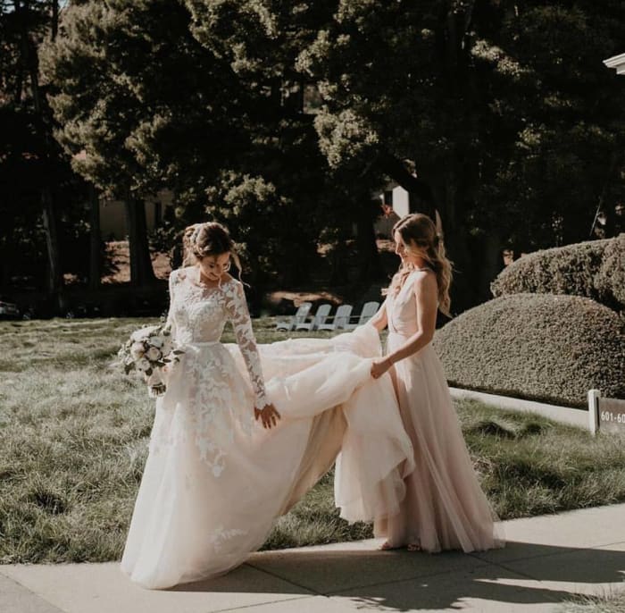Reny wears her custom-designed Anomalie wedding dress. Photo: Feather + North