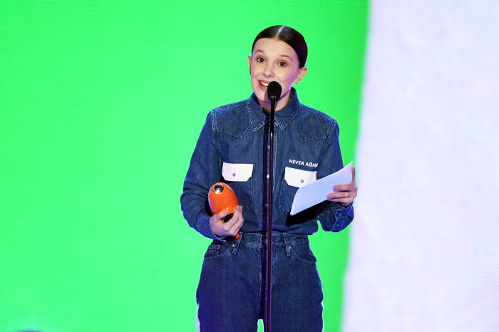 Millie Bobbie Brown accepting her award for Favorite TV actress at the 2018 Kids' Choice Awards in a custom Calvin Klein ensemble. Photo: Kevin Winter/Getty Images