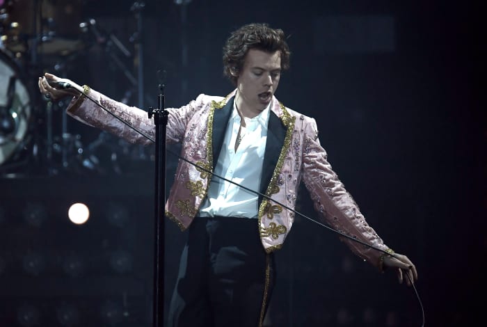 Harry Styles in a custom Gucci suit performing in London on Wednesday. Photo: Gareth Cattermole/Getty Images
