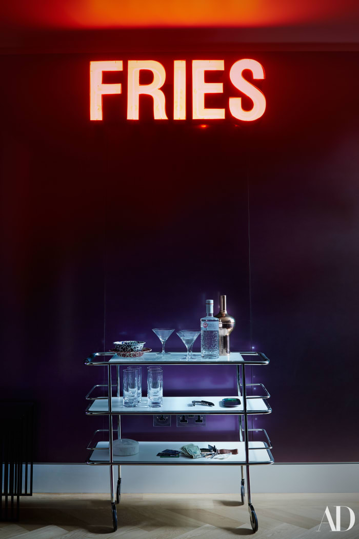 Cara Delevingne's bar cart with a "Fries" sign she'd picked up before moving in. Photo: Skyler Smith/Architectural Digest