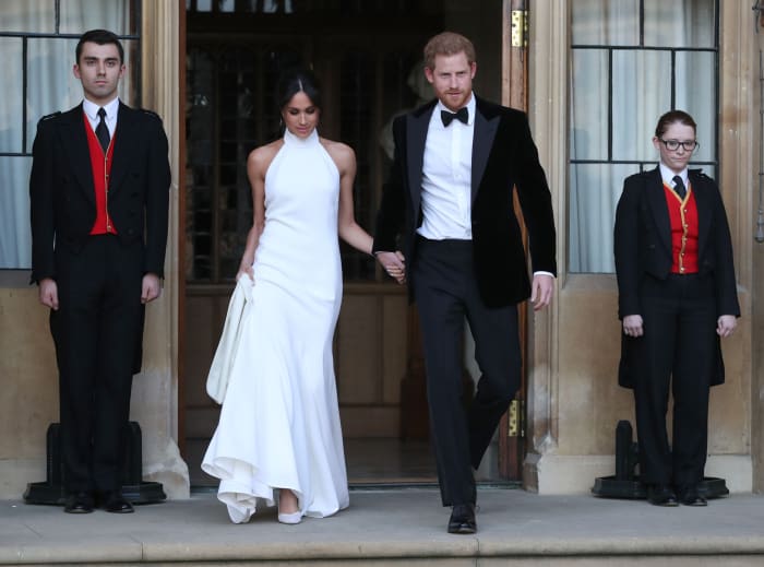 Meghan Markle in Stella McCartney and Prince Harry depart for their evening wedding reception. Photo: STEVE PARSONS/AFP/Getty Images