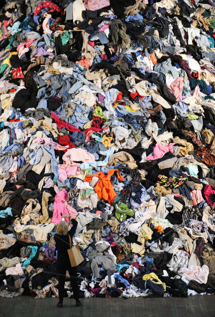 A woman photographs French artist Christain Boltanski's "No Man's Land.'" Photo: Stan Honda/AFP/Getty Images