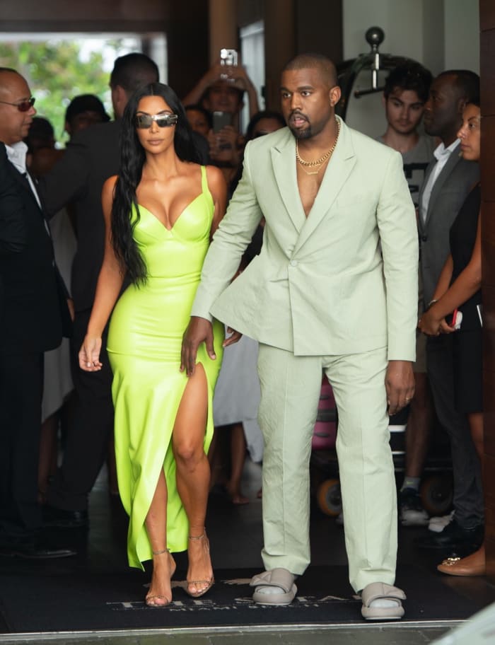 Kim Kardashian in slime green and Kanye West in Louis Vuitton at 2 Chainz's wedding. Photo: Courtesy of Louis Vuitton