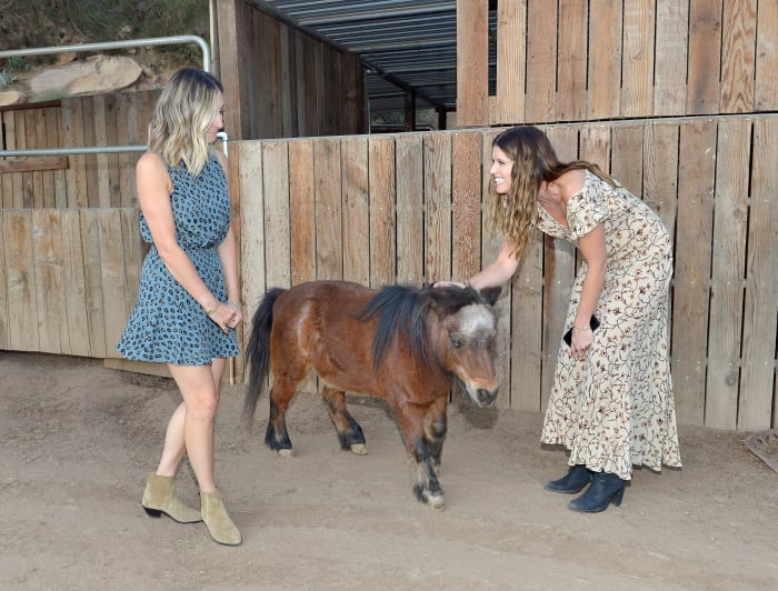 Emily Schuman and Katherine Schwarzenegger welcome a dinner guest. Photo: Courtesy of Fossil/Donato Sardella/Getty Images for Fossil