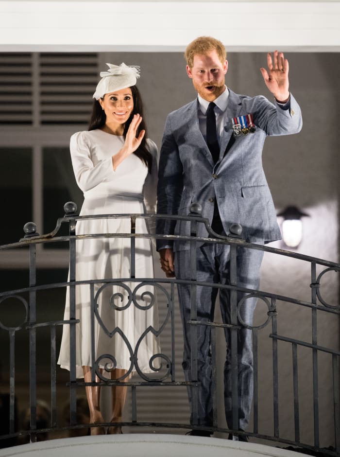 The Duke and Duchess of Sussex wave from the balcony of the Grand Pacific Hotel in Suva, Fiji on Tuesday. Photo: Samir Hussein/WireImage
