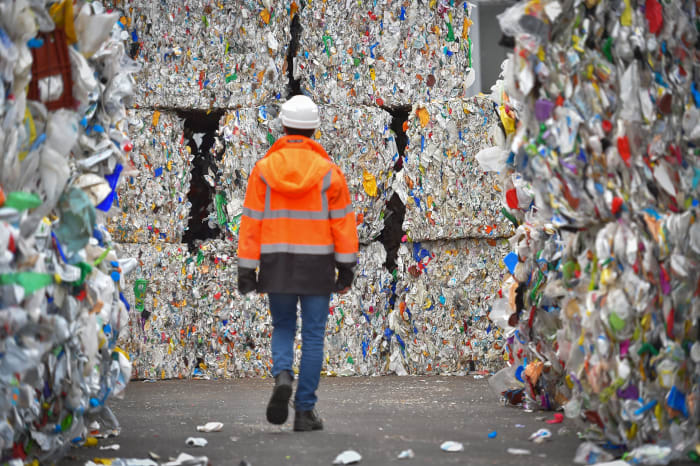 An employee walks through plastic waste waiting to be recycled at a sorting center in France. Photo: Loic Venance/AFP/Getty Images