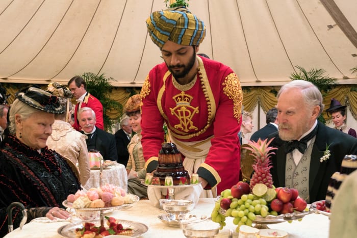 Queen Victoria (Judi Dench), Abdul Karim (Ali Fazal), a jello mold and Sir Henry Ponsonby (Tim Pigott-Smith) Photo: Peter Mountain / Focus Features