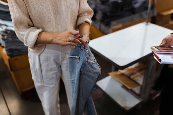 Creative Director Karen Phelps points out a pair of jeans that have been marked as flawed during the quality control process. Photo: Jacob Boll/Fashionista