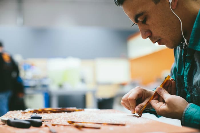 A State Optical Co. factory employee hand-polishes a pair of frames. Photo: Courtesy of State Optical Co.