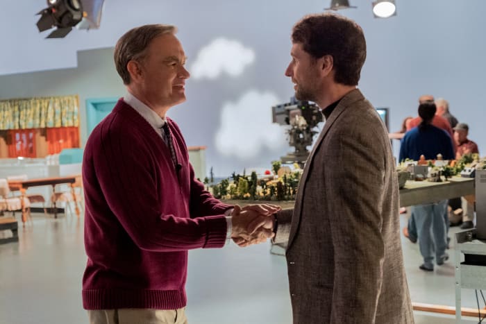 Fred Rogers (Tom Hanks) welcomes reporter Lloyd (Matthew Rhys) to the "Mister Rogers' Neighborhood" set. Photo: Lacey Terrell/Courtesy of Sony Pictures Entertainment