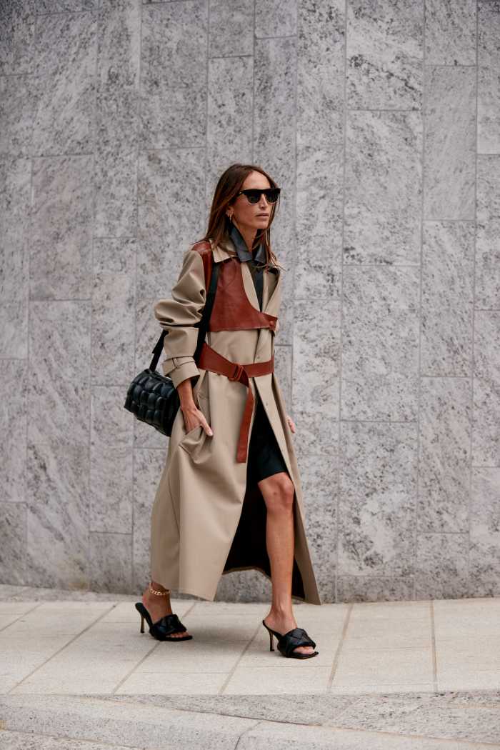 A showgoer carrying a Bottega Veneta bag and wearing Bottega Veneta shoes during Milan Fashion Week in September 2019.