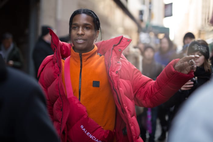 A$AP Rocky wearing an orange Calvin Klein fleece at Calvin Klein's Fall 2017 show during New York Fashion Week.