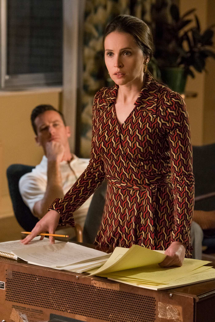 Ruth in a vintage DVF dress with Marty, in his signature short sleeve button-down, looking on. Photo: Jonathan Wenk/Focus Features