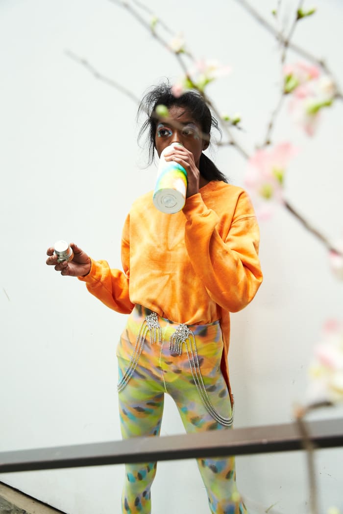 A model backstage at Collina Strada's Fall 2019 show drinking from a reusable water bottle painted to match her outfit. Photo: Soraya Zaman/Courtesy of Collina Strada