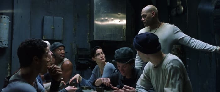Tank (Marcus Chong), Switch (Belinda McCrory), Dozer (Anthony Ray Parker), Trinity, Mouse (Matt Doran), Morpheus (standing, Laurence Fishburne) and Neo in reality aboard the Nebuchadnezzar hovercraft. The movie featured color codes: blue in reality and green in The Matrix (above). Photo: Screengrab/The Matrix