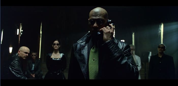 Cypher (Joe Pantoliano), Mouse, Trinity, Morpheus, Switch (Belinda McCrory) and Apoc (Julian Arahanga) in The Matrix. "Fantasy croc," says Barrett, describing the specialty-printed embossing on Morpheus's coat, which was made in both leather and lighter weight fabrics. Photo: Screengrab/The Matrix