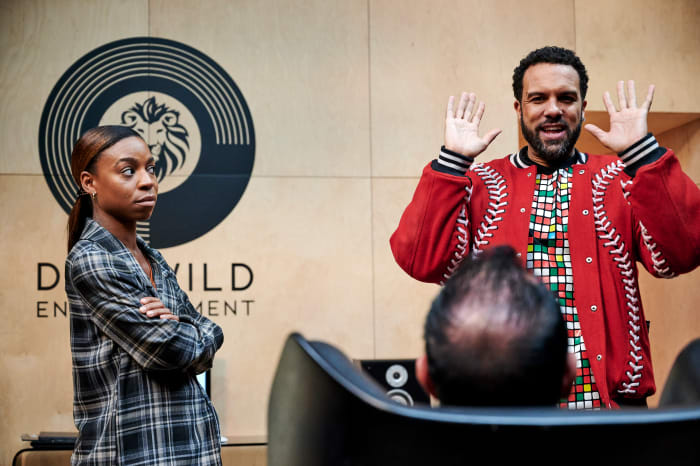 Stats whiz Tamzin (Pippa Bennett Warner) in her 'librarian' aesthetic, Don Wild (Christopher Meloni, seated) and Maxxx (O-T Fagbenle) in his trusty KTZ bomber.
