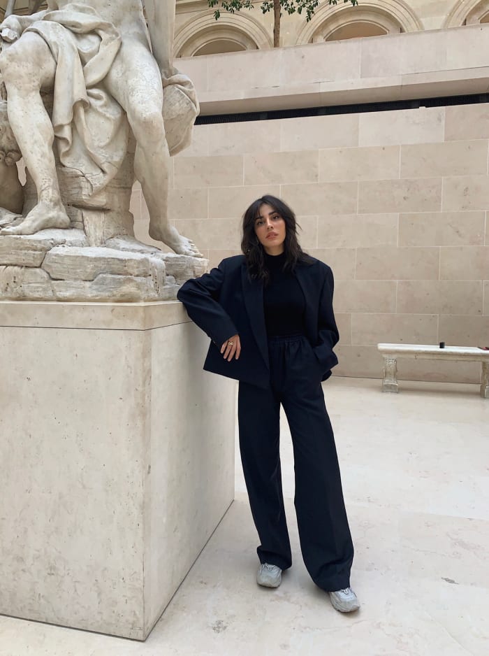 Carloto in an Acne jacket and black turtleneck at the Louvre in Paris.