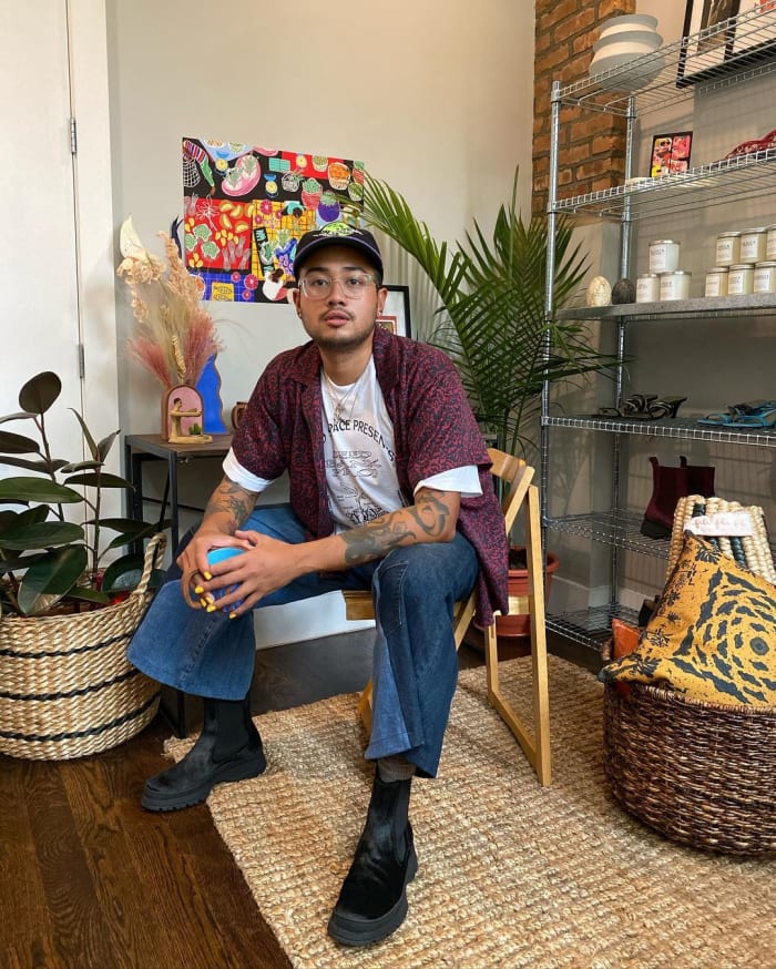 Jan Vincent Gonzales surrounded by wares from Filipino brands he represents.