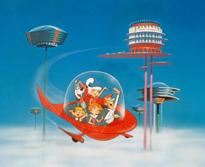 The Jetson family wave as they fly past neighbors in their spaceship in a still from "The Jetsons," circa 1962.