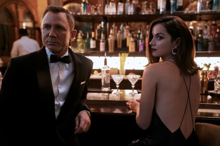 Daniel Craig as James Bond and Ana de Armas as Poloma in 'No Time to Die,' costume design by Suttirat Larlarb.