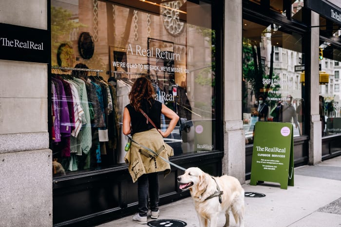 A customer waits to enter The RealReal store on Madison Avenue in New York City in September 2020.