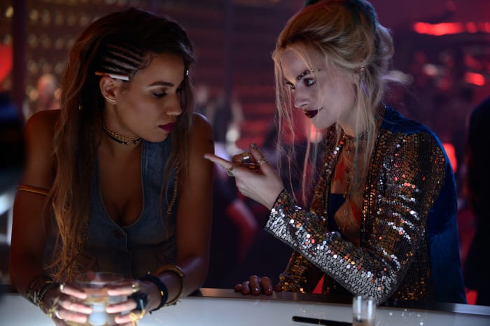 "It was such a great party piece," says Benach, about Harley's Attico silver sequin sleeve and teal velvet back panel duster by Attico (right, with Black Canary, left).