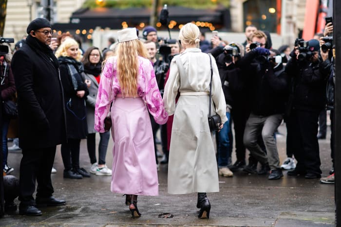 Influencers being photographed outside a Nina Ricci show.