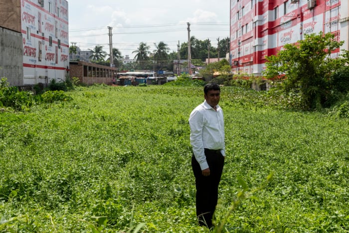 Journalist who entered Rana Plaza one day before it collapsed, standing on the now barren Rana Plaza site.
